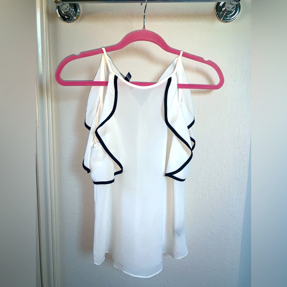 Small white blouse with black lining on cold shoulder sleeves